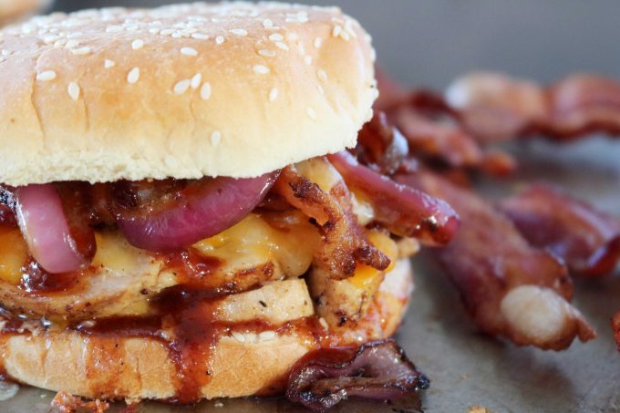 BBQ Chicken Sandwich and off to the right hand side are strips of crispy bacon. 