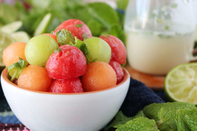 Melon Ball Fruit Salad served in a small white bowl. 