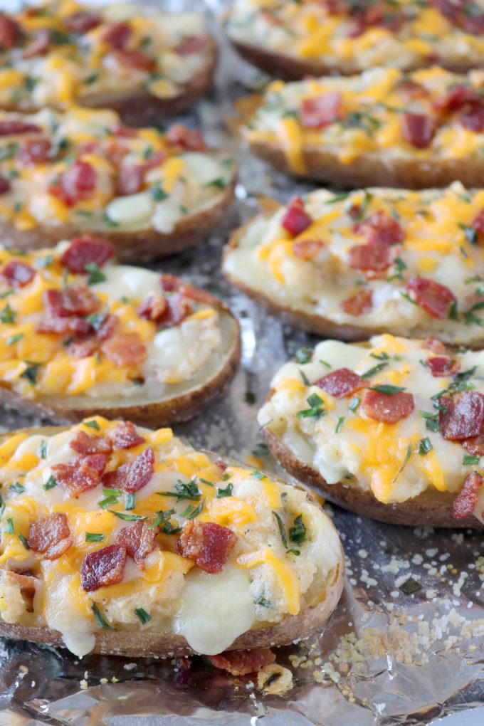 Twice Baked Potatoes in two rows on aluminum foil. 