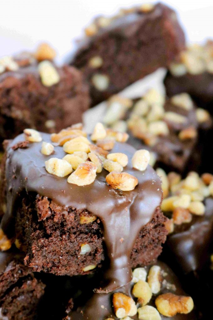 A close up of Fudgy Brownies topped with Walnuts. 