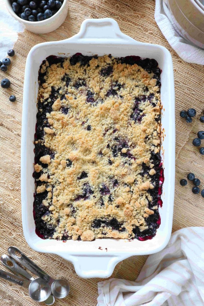 An overhead shot of Blueberry Bars that have been baked in a white casserole dish. 
