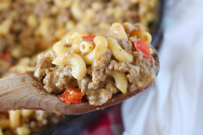 A spoonful of Homemade Hamburger Helper on a wooden spoon. 