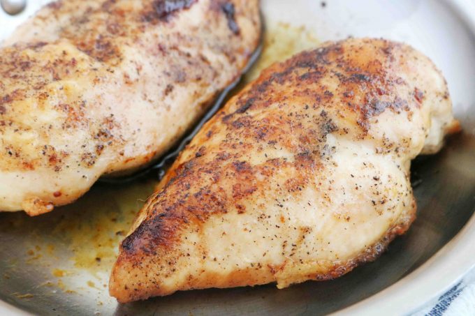 Perfectly cooked Pan-Seared Chicken breasts in a pan.