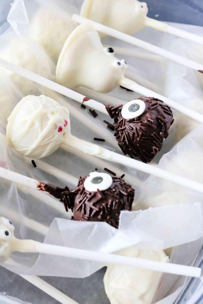 Decorated cake pops lying flat on wax paper. 