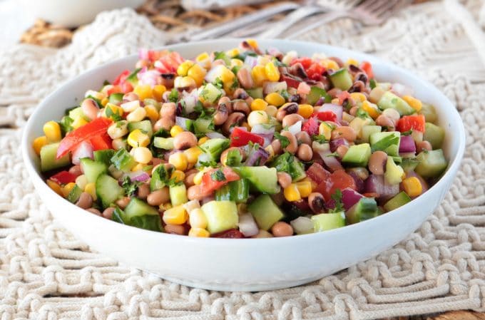 A white bowl full of Black Eyed Pea Salad. 