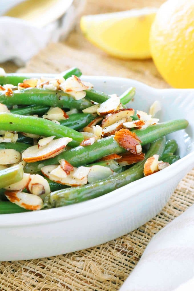 Green Bean Almondine served in a white oval baking dish. 