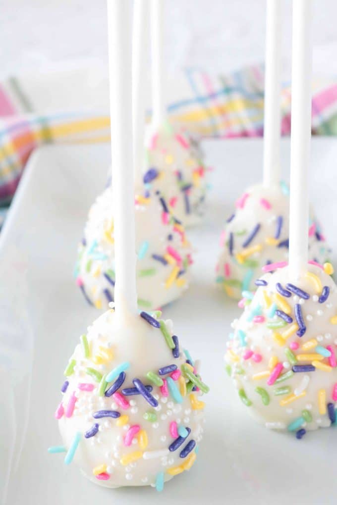 Easter Egg Cake Pops placed on a white rectangle plate. 