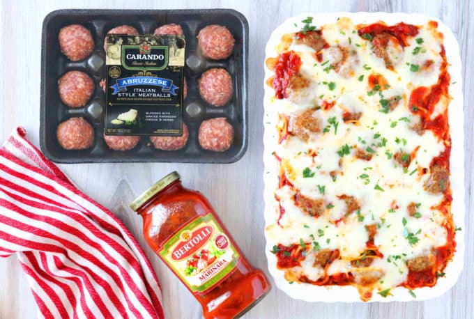 An overhead shot of meatball casserole and lying next to it are a package of meatballs and marinara sauce. 