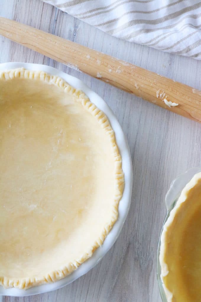 Pie crust that has been rolled and transferred to a pie dish.