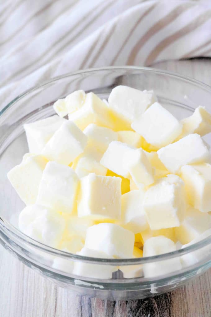 Cubes of cold butter and shortening in a bowl.