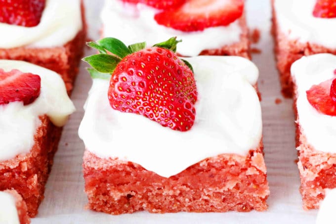Strawberry brownies on a cooling rack.