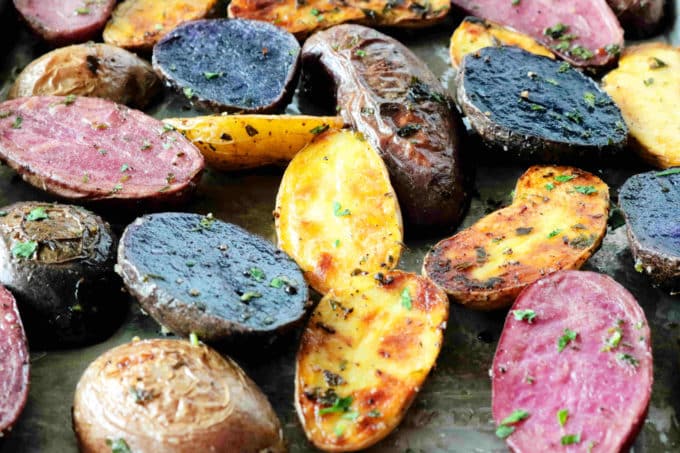 A close up shot of potatoes roasted on a sheet pan.