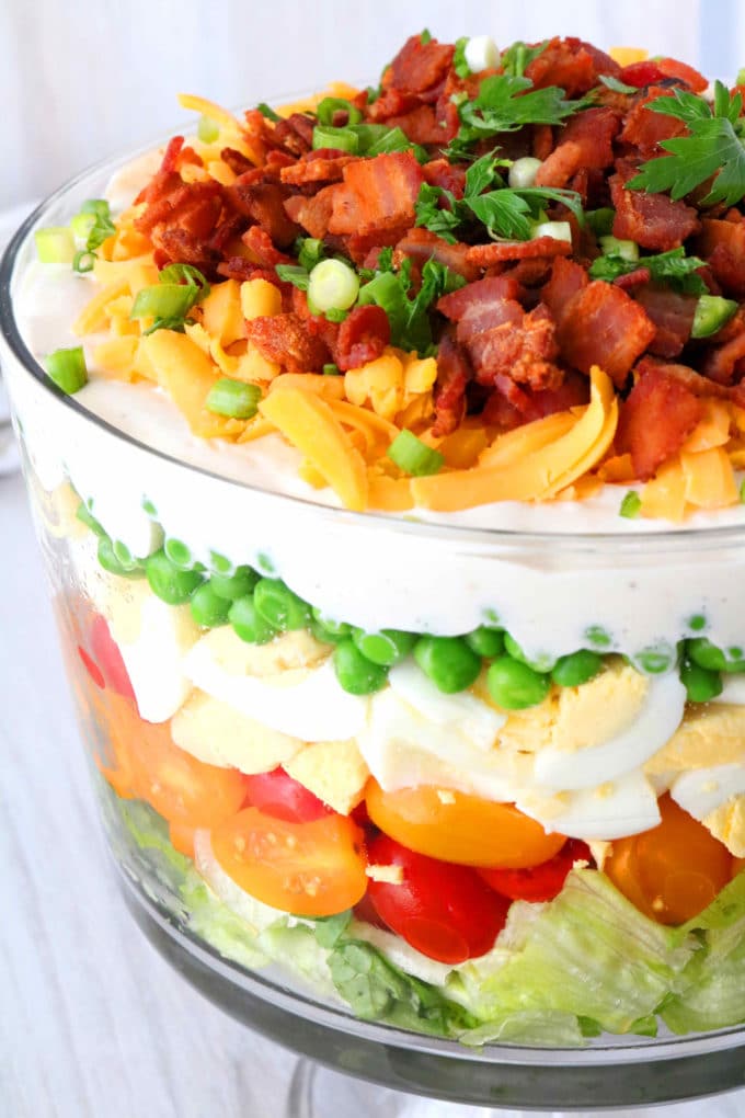 Seven Layer Salad in a trifle bowl.