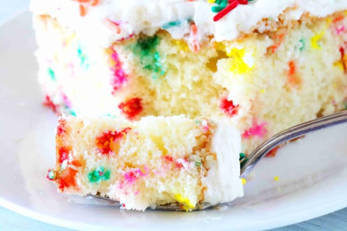 A close up shot of a bite of Funfetti Cake on a fork.