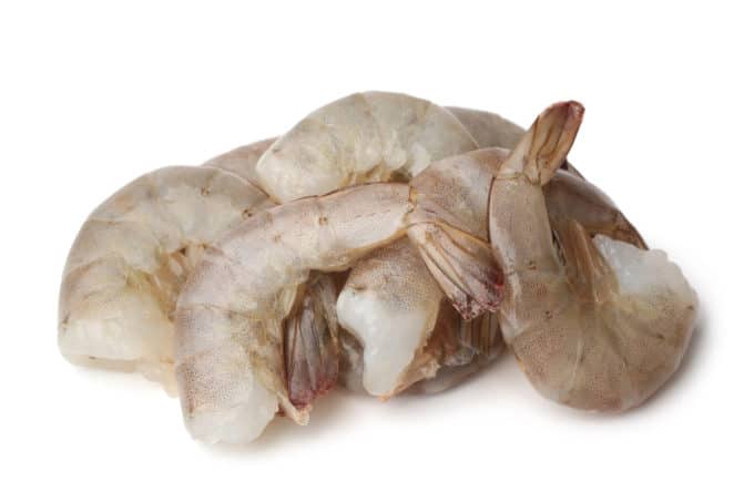 Raw shrimp with the shell and tail on.
