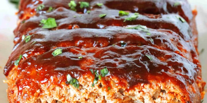 A front view of sliced BBQ Meatloaf topped with BBQ Glaze.