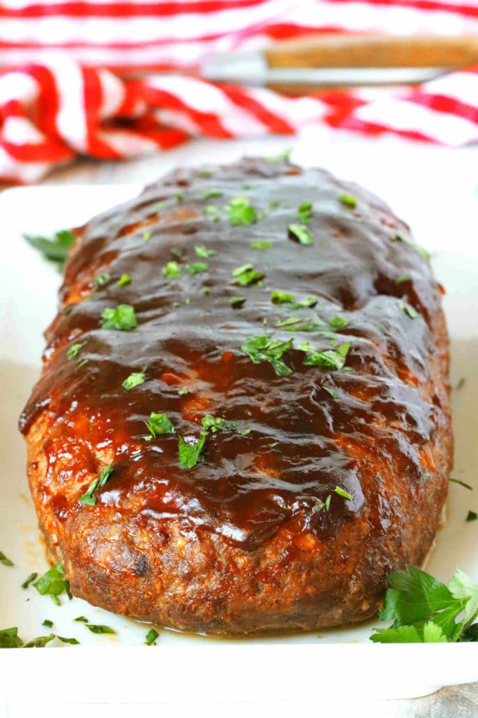 A whole, uncut loaf of BBQ Meatloaf on a platter.