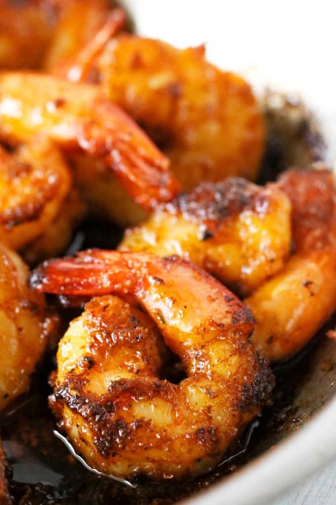 A close up shot of Blackened Shrimp cooked in a saute pan with butter in the bottom of the pan.