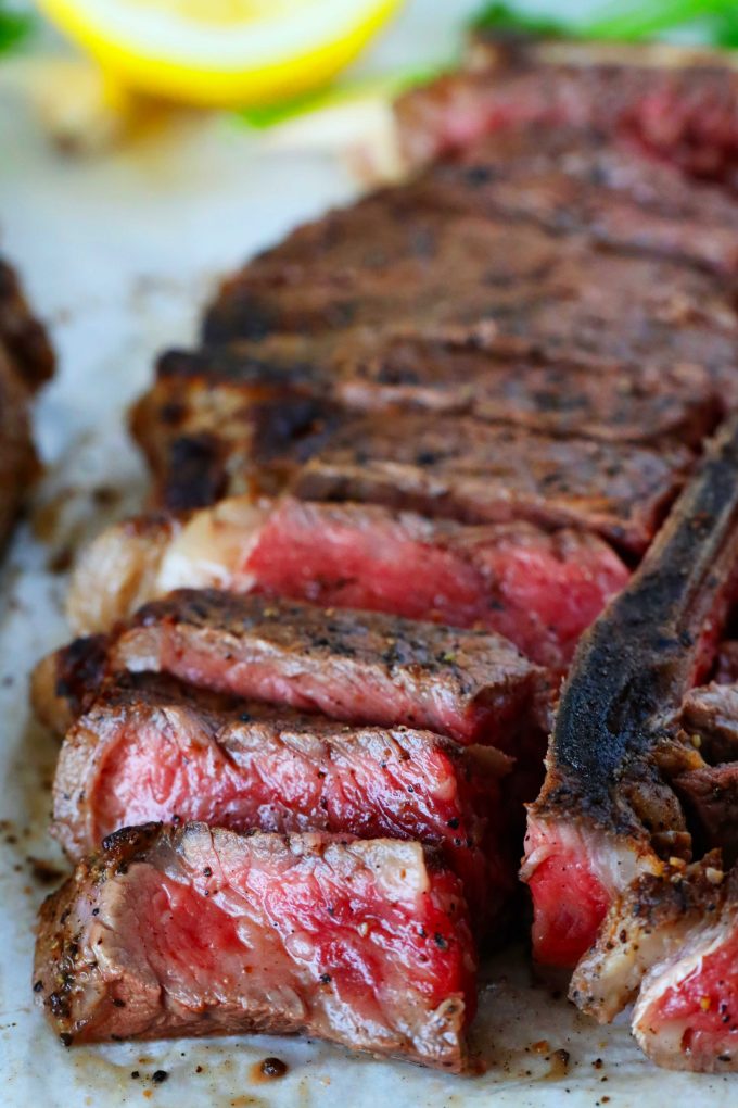 A close up shot of a sliced porterhouse steak.