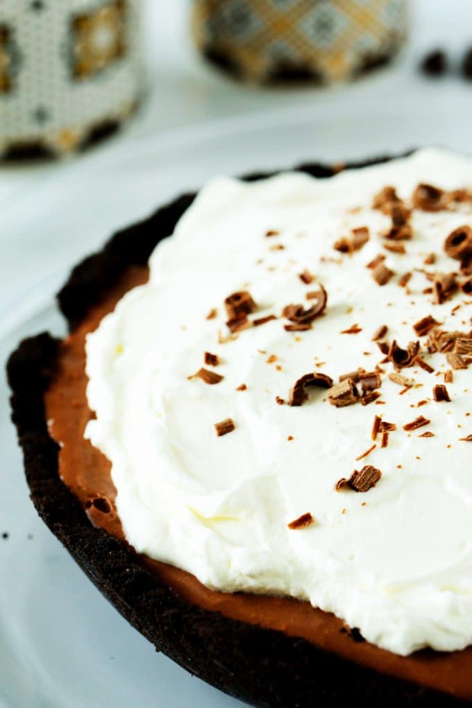 A close up shot of whipped cream on a no bake chocolate pie.