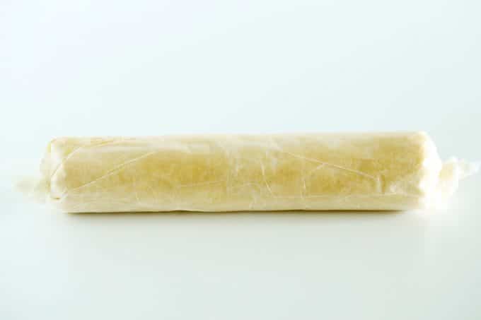 A log of cookie dough wrapped in wax paper.