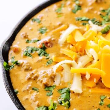A close up shot of chili cheese dip in a skillet.