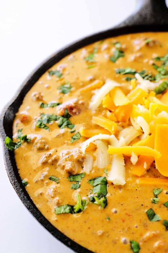 A close up shot of chili cheese dip in a skillet.