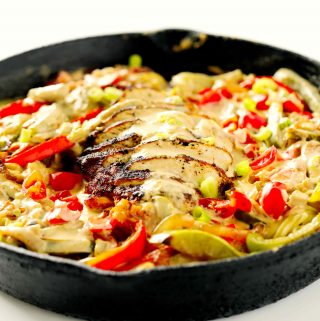 Cajun Chicken Alfredo Pasta in a cast iron pan.