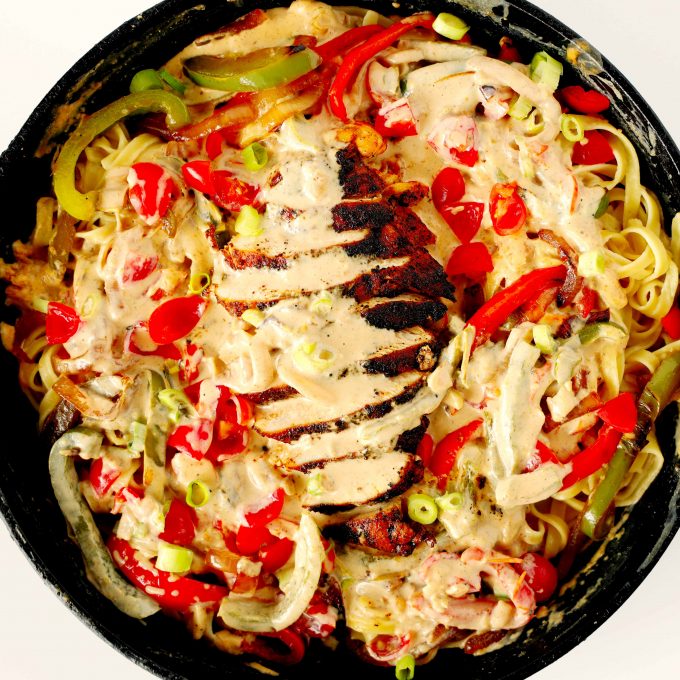 Cajun Chicken Alfredo Pasta in a cast-iron skillet.