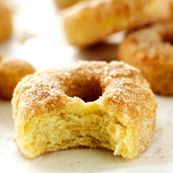 A close up of a cinnamon sugar air fryer donut with a bite taken out of it.