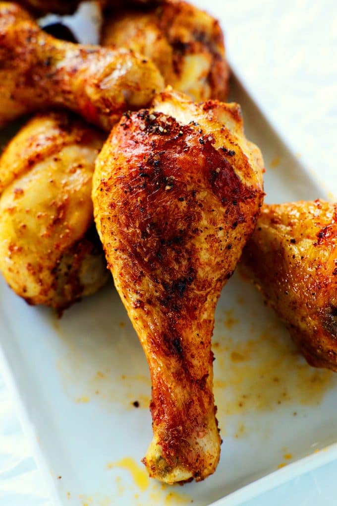 A close up shot of Air Fryer Drumsticks on a white platter.