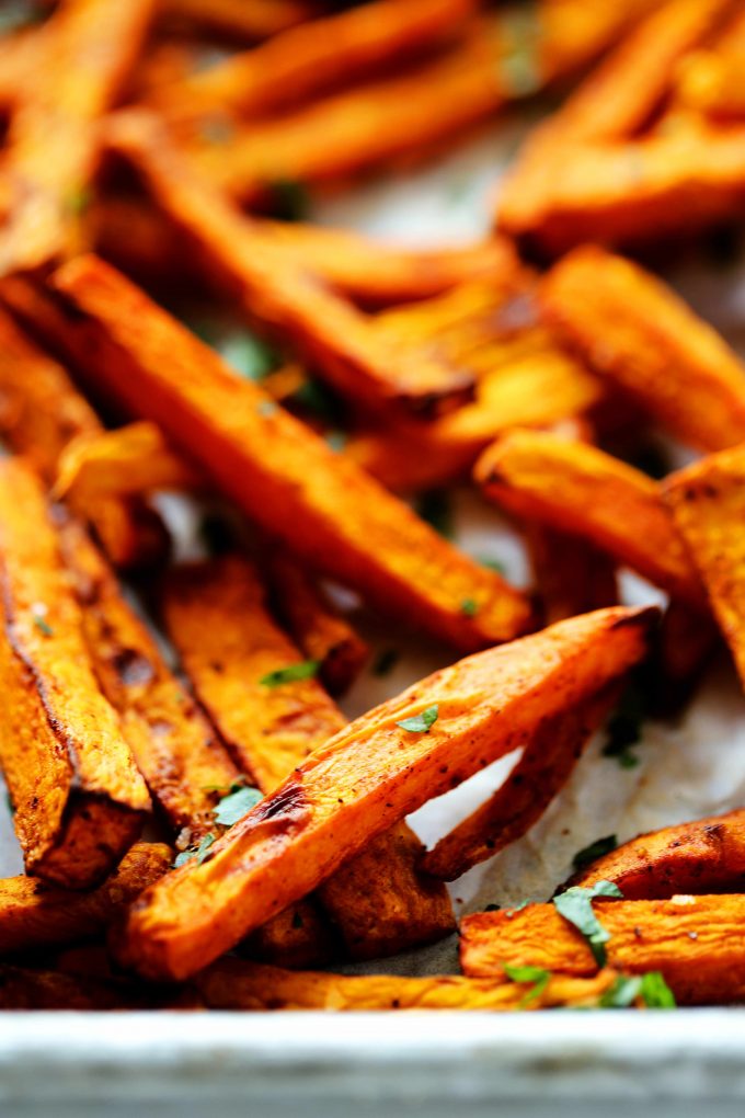 An close up shot of air fryer sweet potato fries on a baking sheet.