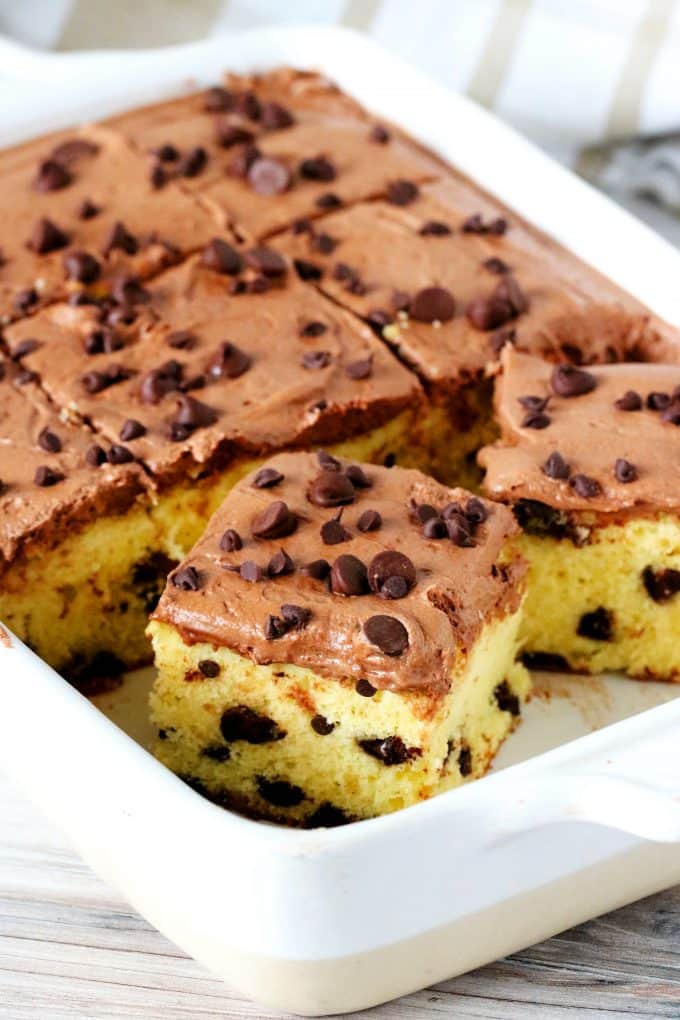 Sliced chocolate chip cake in a white baking dish. 