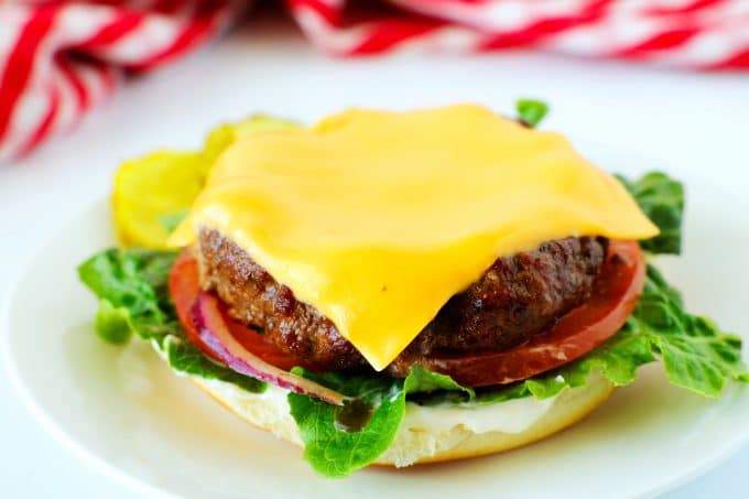 An air fryer burger patty topped with cheese.
