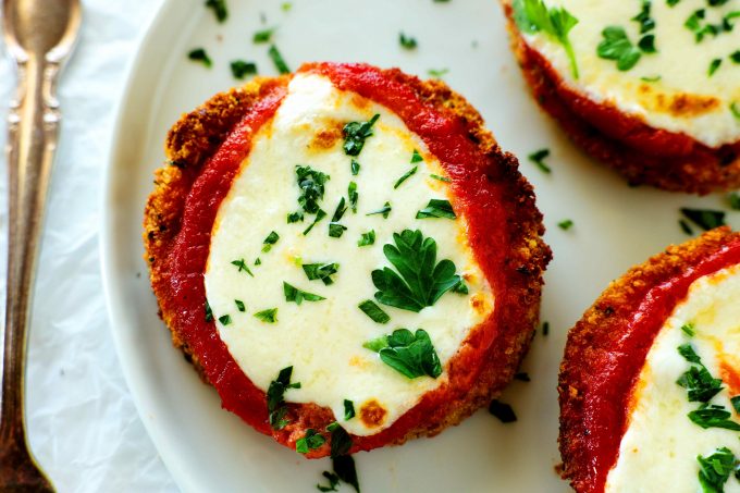 An overheat shot of air fryer eggplant topped with marinara and mozzarella cheese.