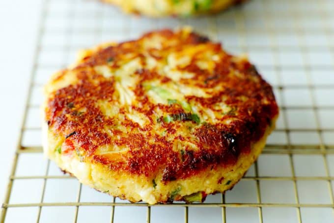 A crab cake on a cooling rack.
