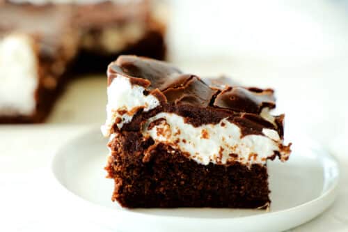 A marshmallow brownie on a white plate.