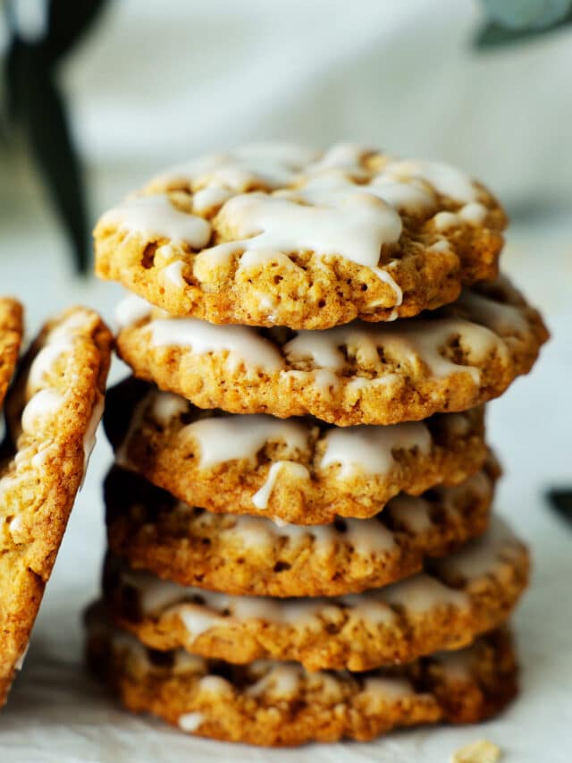 A stack of iced oatmeal cookies.