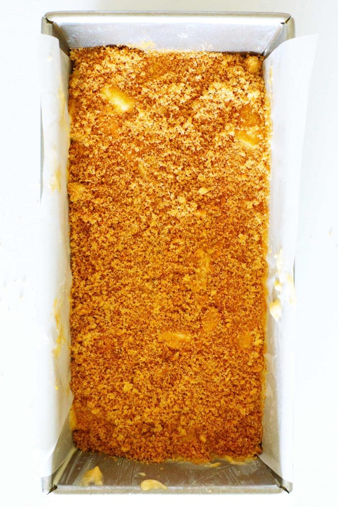 Batter in a loaf pan topped off with a cinnamon brown sugar mixture.