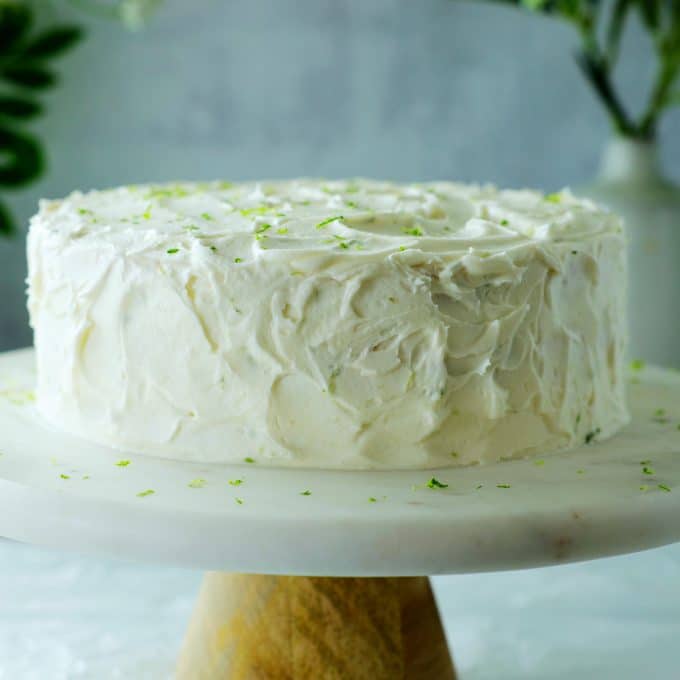 Key lime cake on a cake stand.