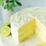 Key Lime Cake with a slice cut out of it.