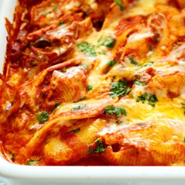 A close-up shot of Mexican stuffed shells in a white casserole dish.