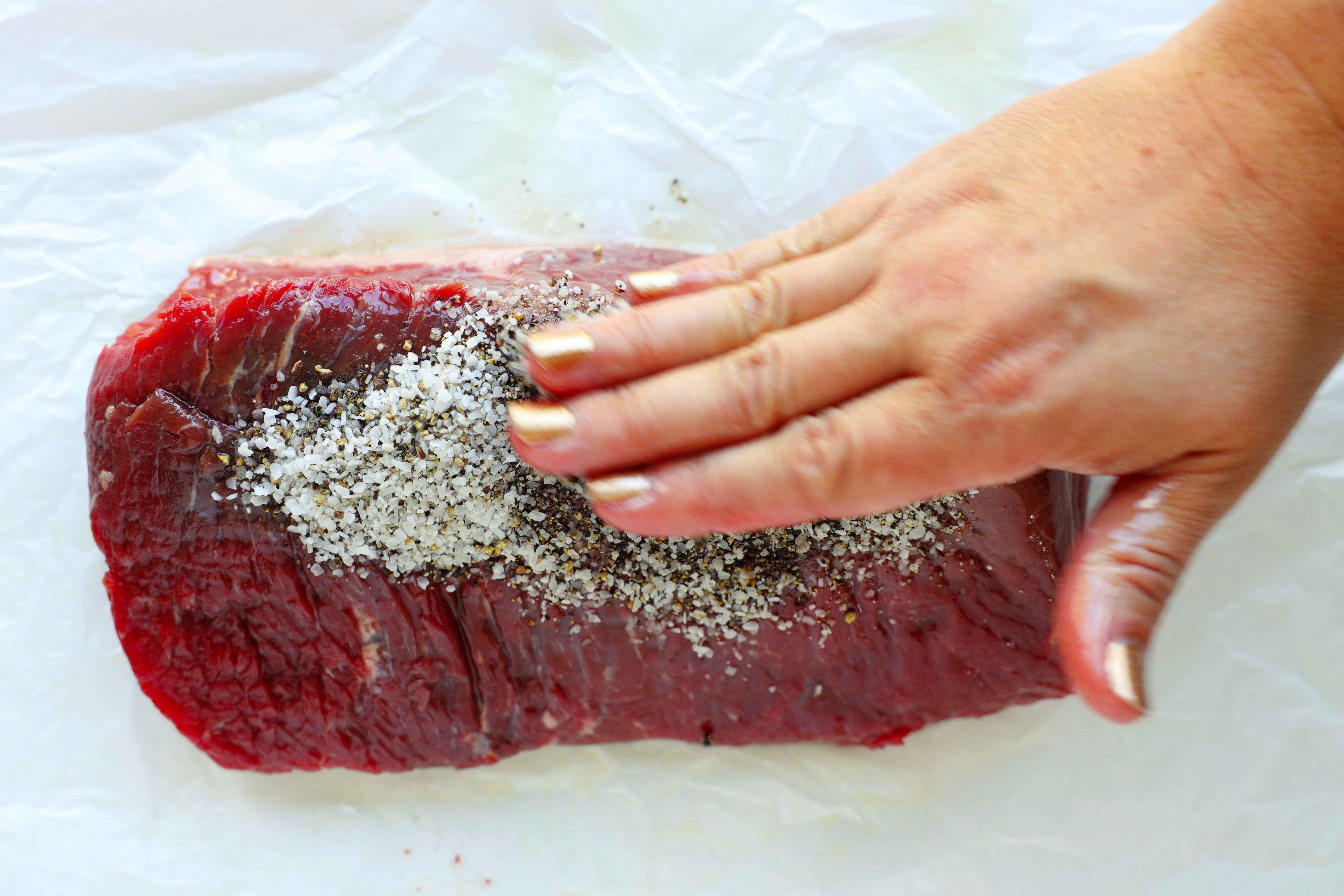 Rubbing seasoning on a rump roast