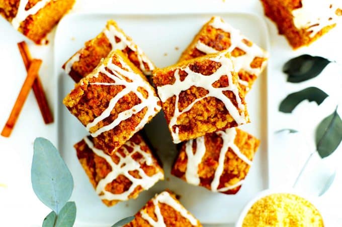 An overhead shot of pumpkin coffee cake slices drizzled with a vanilla glaze.