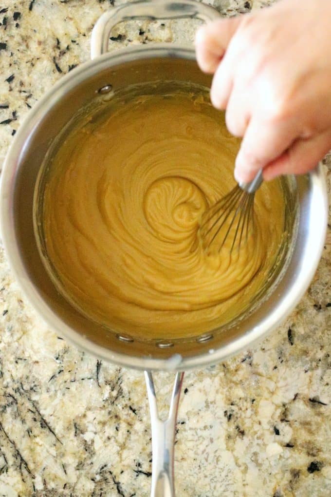 Butterscotch putting in a sauce pan being whisked.