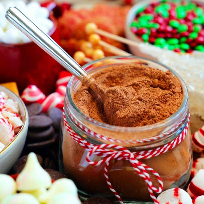 Hot cocoa mix with a spoon inside of the jar.