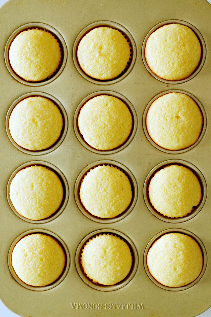 Baked vanilla cupcakes in a pan.