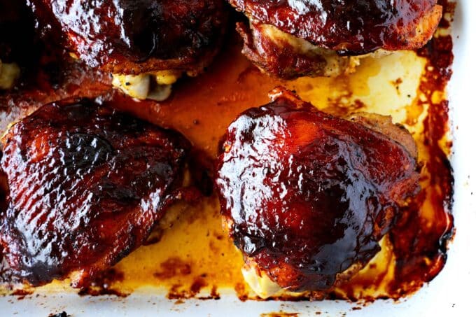 Barbecue chicken thighs in a casserole dish.