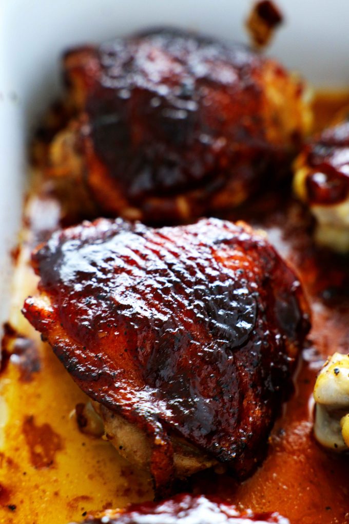 A close-up of a barbecue chicken thigh.