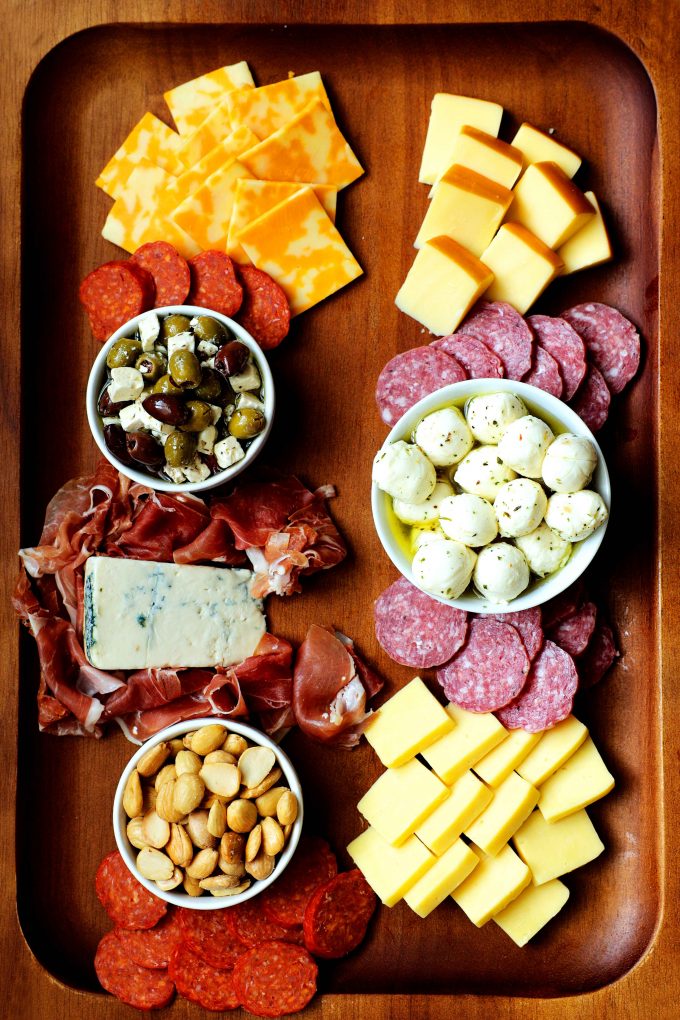 A simple charcuterie board with meat and cheeses in place on the board.